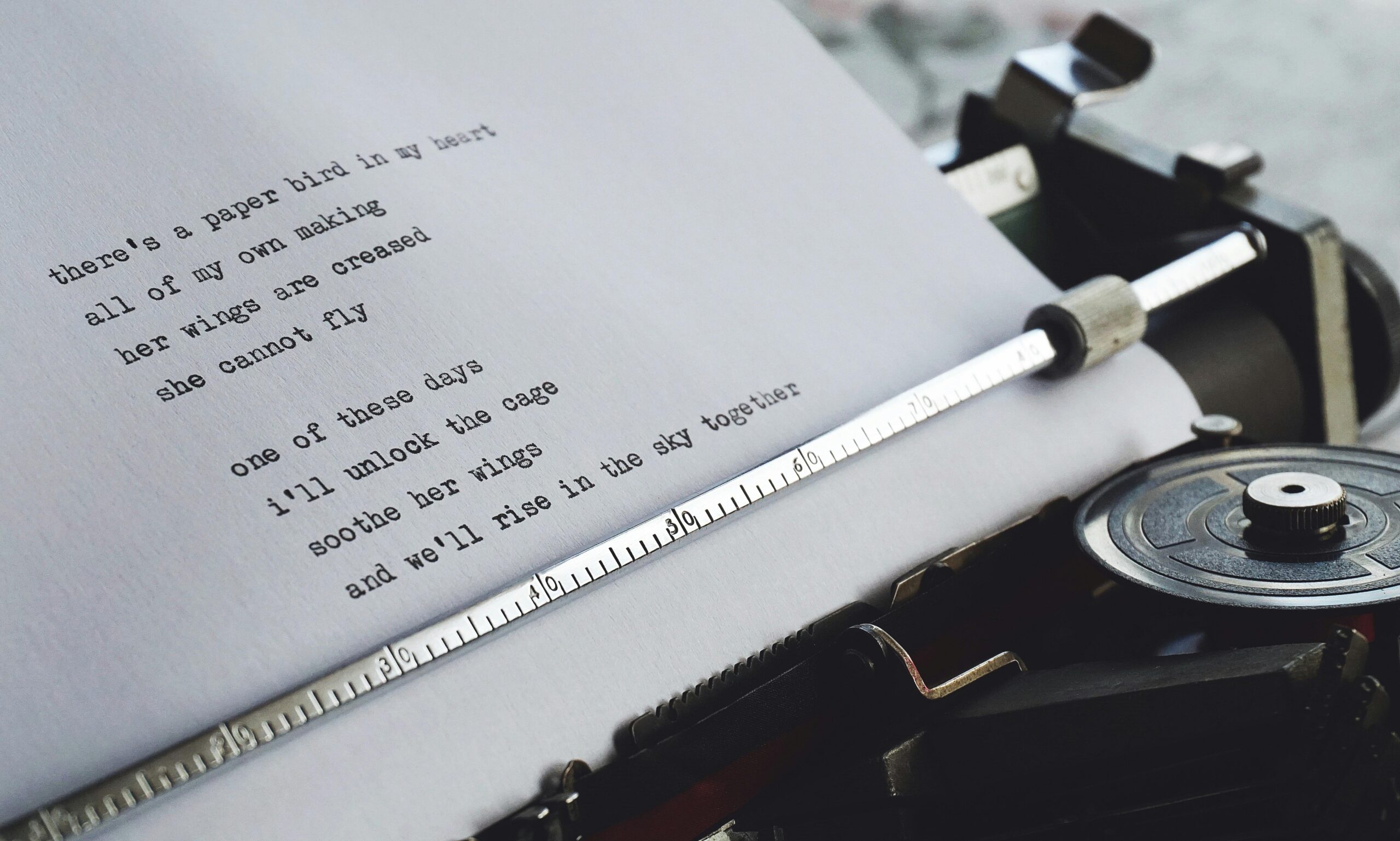 Close-up of a vintage typewriter printing a heartfelt poem on paper.